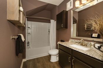 a bathroom with a shower toilet and sink and a mirror  at Watermark on Twenty Mile, Parker, Colorado
